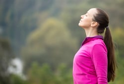 woman breathing in fresh air